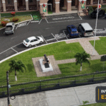 Aerial view of Guyana's Parliament Buildings and grounds, with the Invest Guyana Explains masthead.
