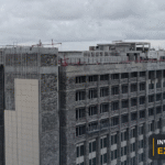 Aerial view of a major Georgetown construction project, with the Invest Guyana Explains masthead.