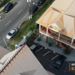 Drone view of the Pegasus Hotel and Georgetown waterfront development, with the Invest Guyana Explains masthead.
