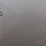 Aerial view of Georgetown waterfront, cargo vessels and river traffic on the Demerara River