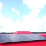 Solar panels mounted on the red roof of the Baracaro Health Post in Region Two.