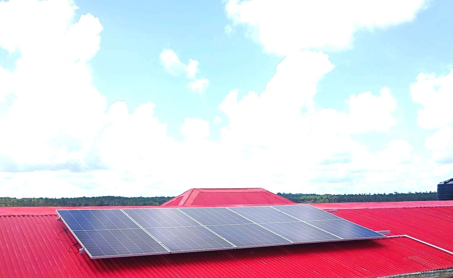 Solar panels mounted on the red roof of the Baracaro Health Post in Region Two.