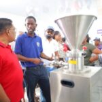 Minister of Agriculture Zulfikar Mustapha views processing equipment at the Canal Number One Polder agro-processing plant.
