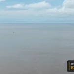 Drone view of the river, vessels and waterfront from Invest Guyana’s original footage.
