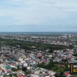 Drone view of the river, vessels and waterfront from Invest Guyana’s original footage.