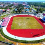 Aerial view of the red synthetic running track and football field at New Amsterdam, Berbice