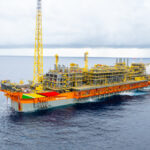The ONE GUYANA FPSO at sea, with an orange hull and yellow topside equipment.