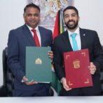 Guyana and Panama officials display signed air-services agreements in Georgetown.